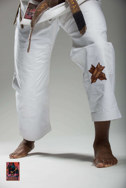 Roninbrand Emperor BJJ Gi in white, showcasing intricate chrysanthemum embroidery, designed for grappling and combat.
