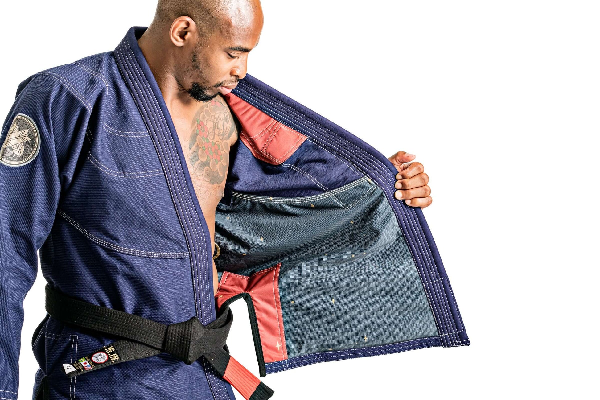 Man showcasing the inner lining of Roninbrand Oni Bushi Navy BJJ Gi, highlighting comfort and design for fighters.
