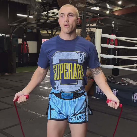 Athlete skipping rope in Superare training gear inside a boxing gym, showcasing dedication and fitness.