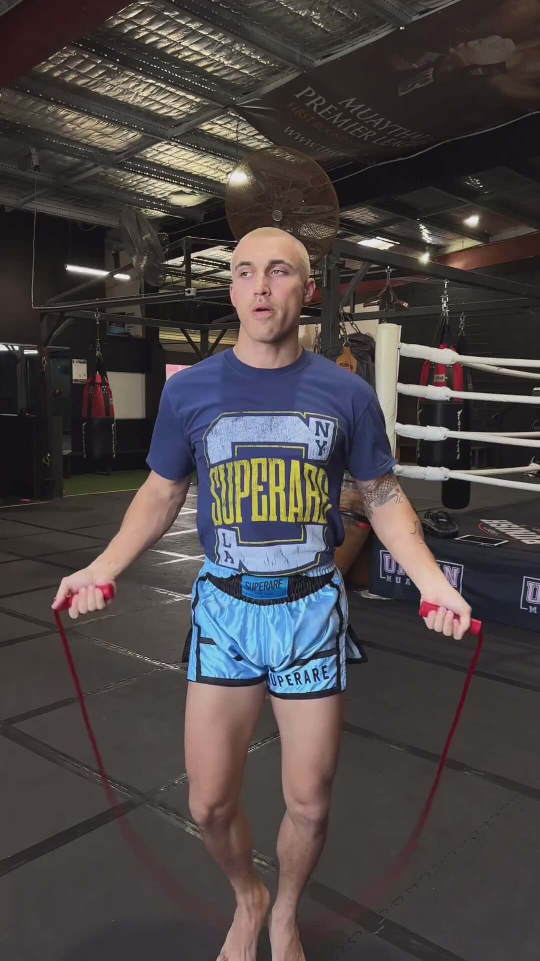 Athlete skipping rope in Superare training gear inside a boxing gym, showcasing dedication and fitness.
