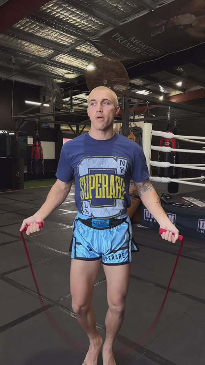 Athlete skipping rope in Superare training gear inside a boxing gym, showcasing dedication and fitness.