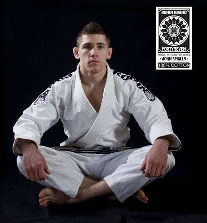 Roninbrand 47 BJJ Gi in white, modeled by John Smalls, showcasing professional Brazilian Jiu Jitsu craftsmanship and comfort.