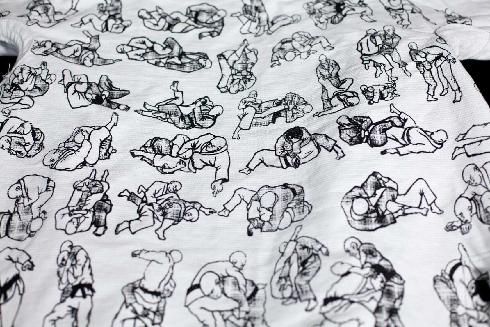 White t-shirt featuring various grappling illustrations, showcasing Brazilian Jiu Jitsu techniques.