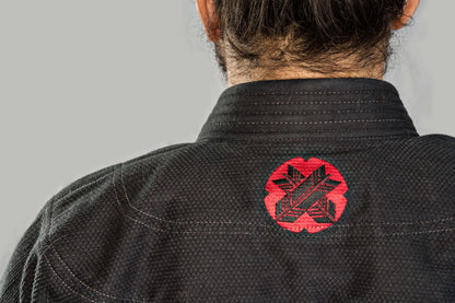 Back view of Roninbrand Samurai Ghost BJJ Gi, featuring a striking red logo on black fabric, designed for elite fighters.