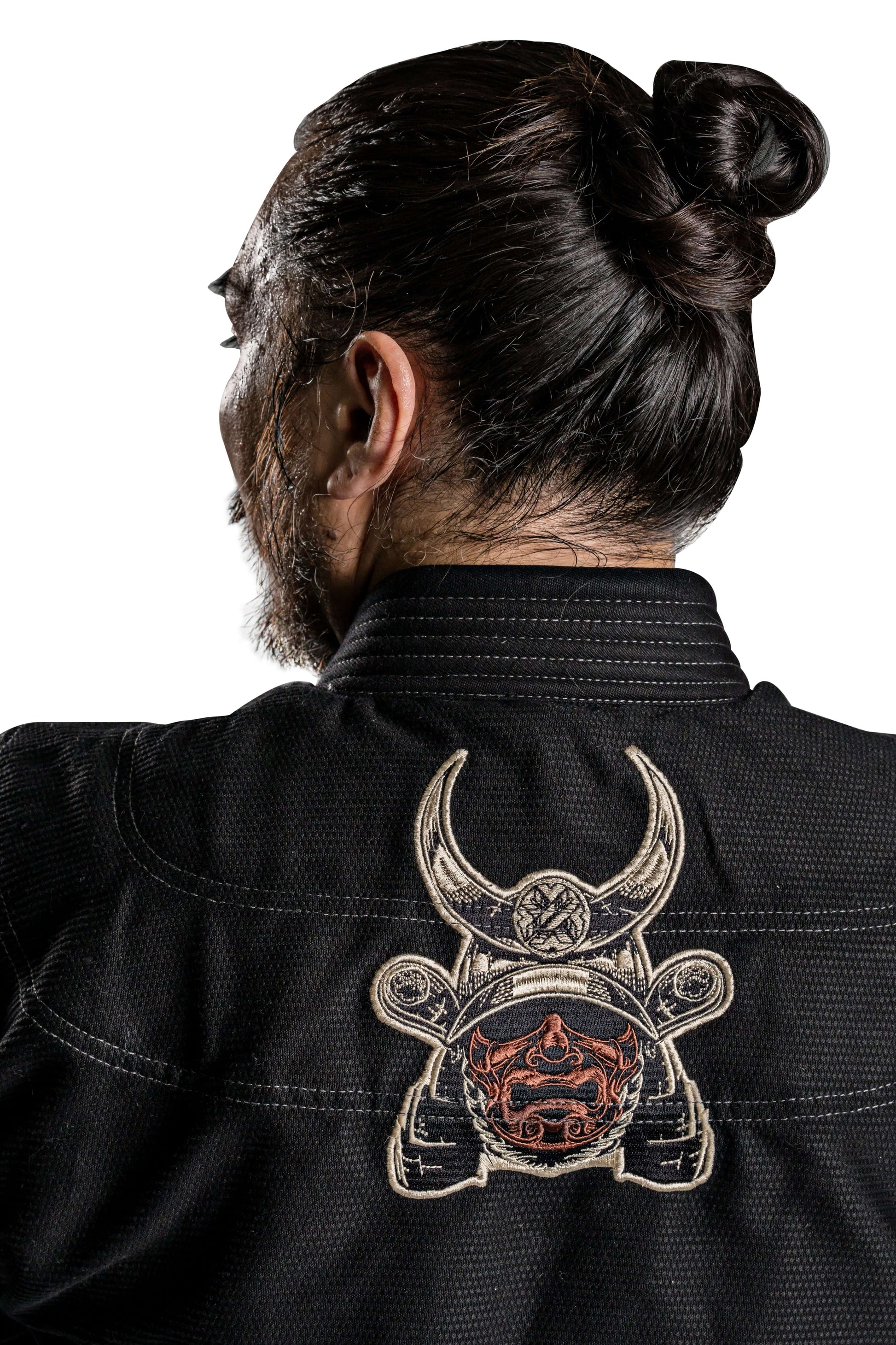 Back view of a man wearing Roninbrand Kurosawa BJJ Gi with samurai design, showcasing craftsmanship and style.