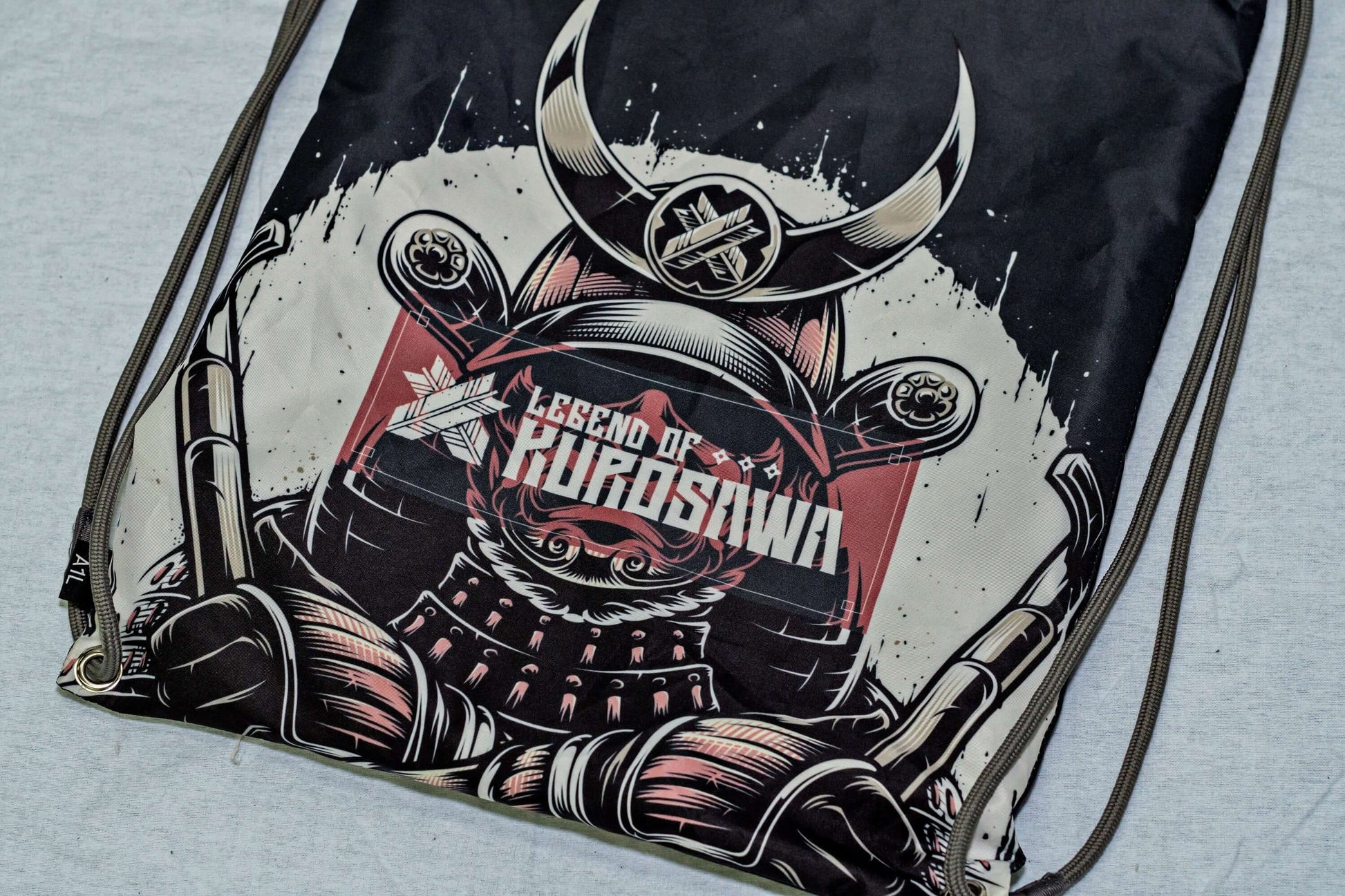 Legend of Kurosawa graphic drawstring bag featuring a samurai design, inspired by Akira Kurosawa's cinematic legacy.