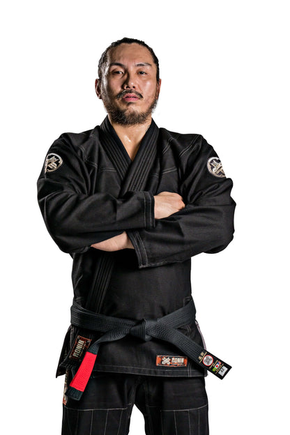 Martial artist wearing the Roninbrand Kurosawa BJJ Gi in black, showcasing strength and readiness for battle.