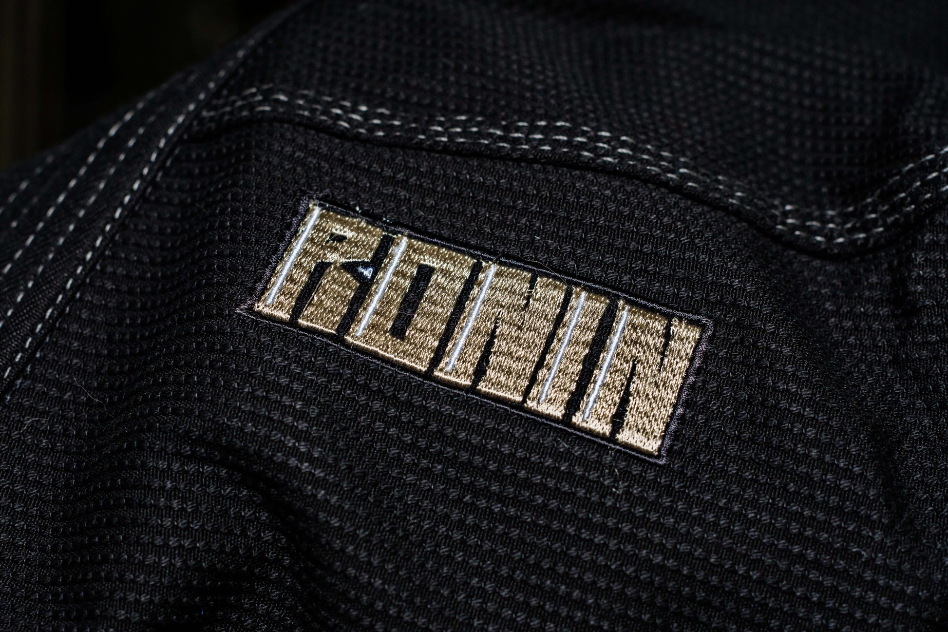 Close-up of the Ronin logo on the black Kurosawa BJJ Gi, symbolizing quality and tradition in Brazilian Jiu Jitsu.