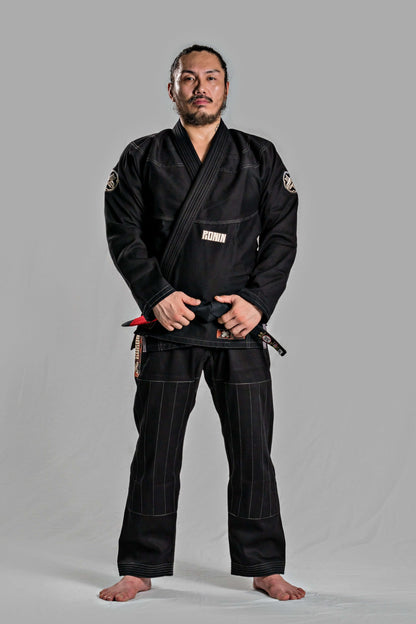 Man wearing Roninbrand Kurosawa BJJ Gi in black, showcasing professional Brazilian Jiu Jitsu attire designed for optimum comfort and fit.