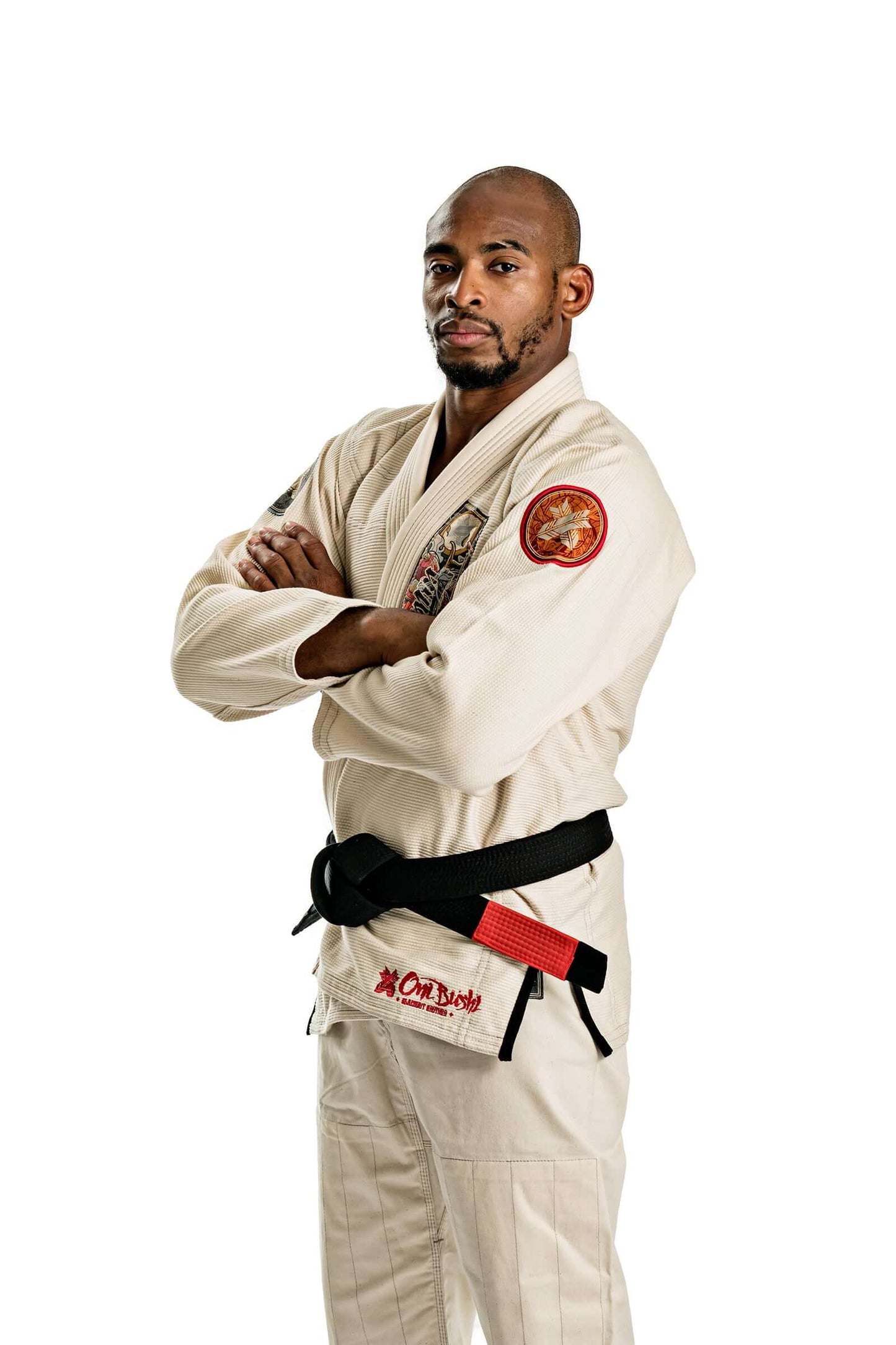 Model wearing Roninbrand Oni Bushi BJJ Gi, showcasing premium unbleached fabric and black belt in a striking pose.